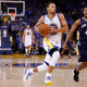Stephen Curry of the Golden State Warriors drives to the hoop against Ish Smith of the New Orleans Pelicans during the NBA season opener in Oakland, Calif., Oct. 27, 2015.
Ezra Shaw/Getty Images